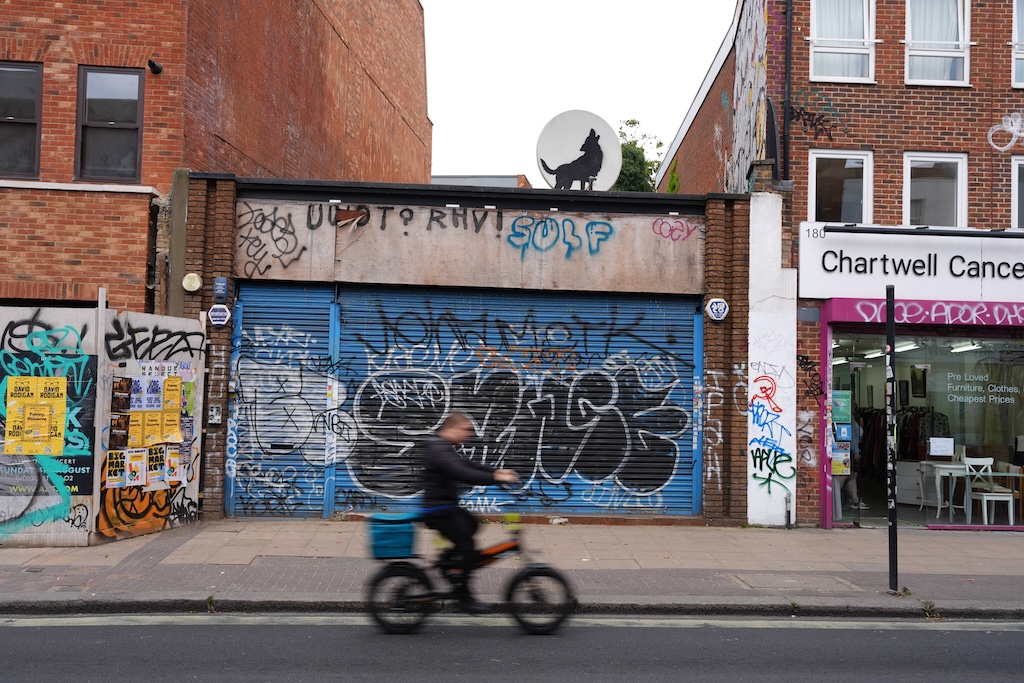 The fourth urban animal mural by Banksy to appear in London features a howling wolf against a satellite dish.