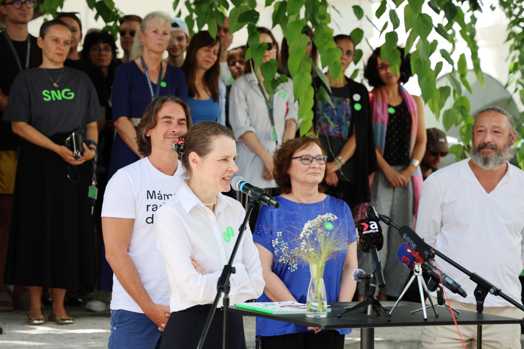 A man and a woman stand behind a podium.